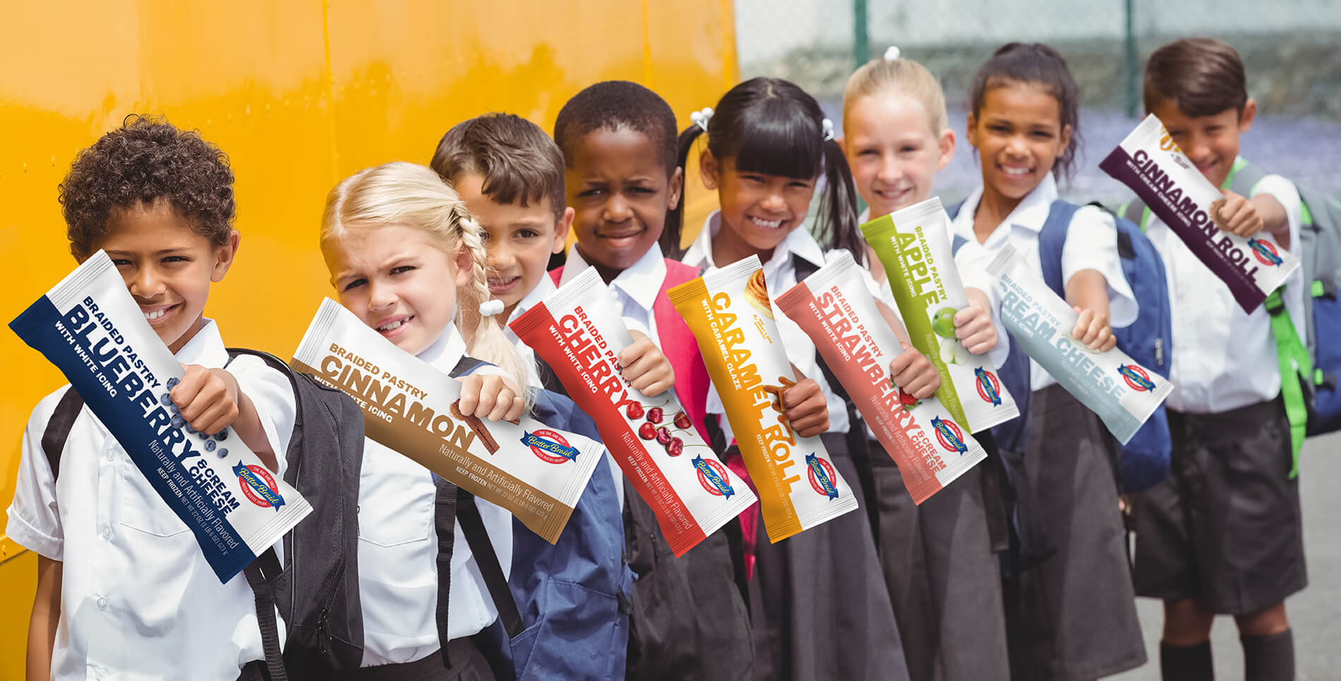 Find a Dealer - Group of school children in front of bus holding Butter Braid Pastry packages