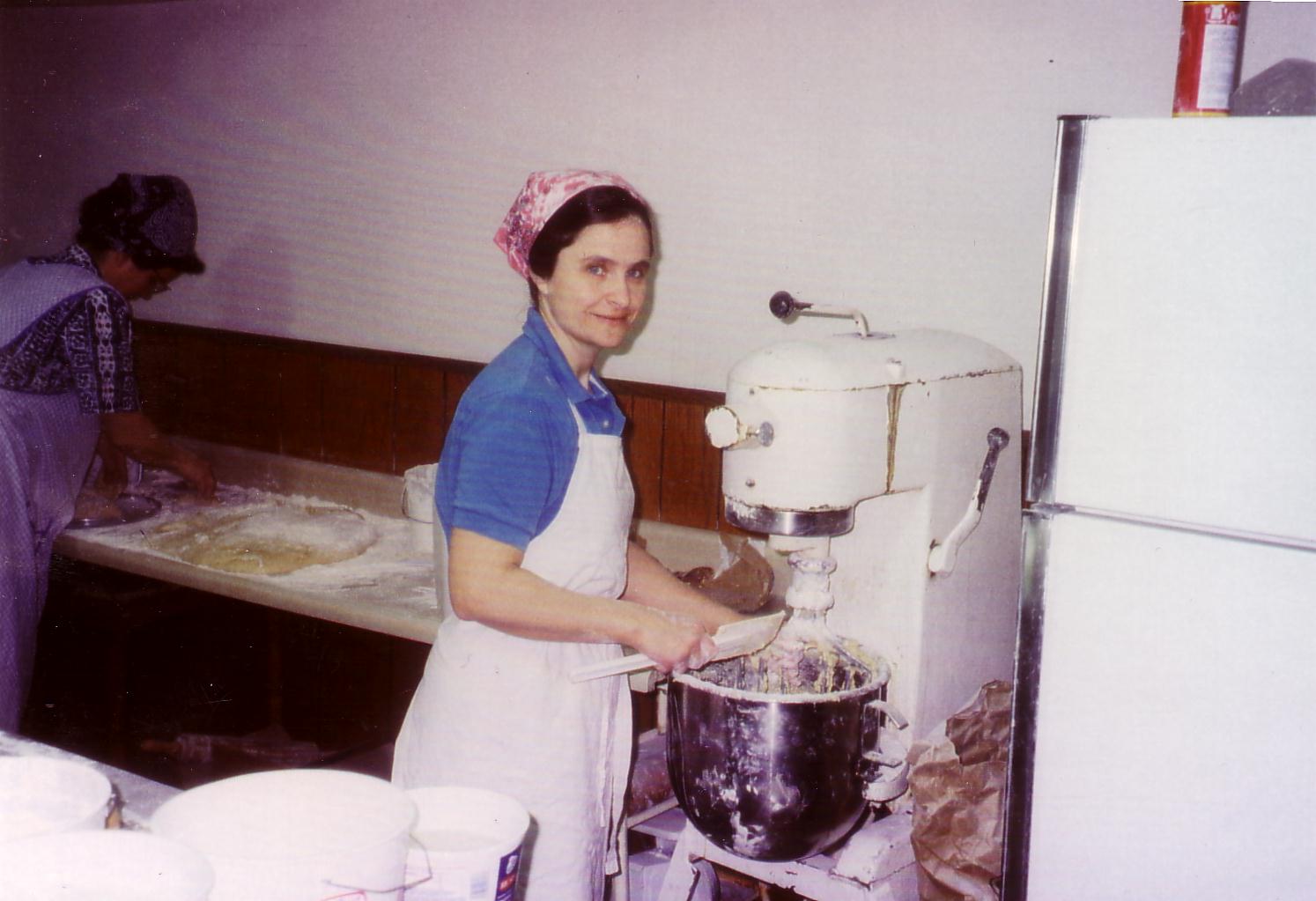Our Story - Marlene Banwart next to old mixer from their kitchen