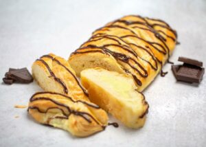 Bavarian Crème Pastry with slices cut off and chocolate pieces as garnish