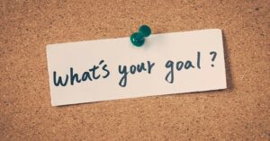 Fundraising goals for new year - "What's your goal?" Written on piece of paper stuck to cork board.