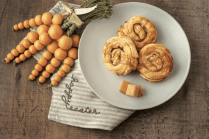 Deep-Fried Caramel Rolls on plate next to carrot décor and a cloth napkin.