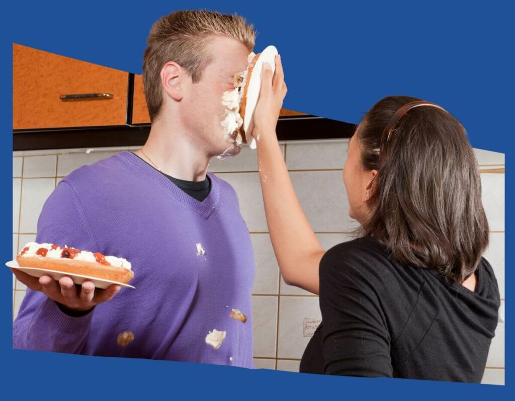 Ways to Motivate Your Sellers - woman throwing a pie into a guy's face. Guy is also holding a pie.