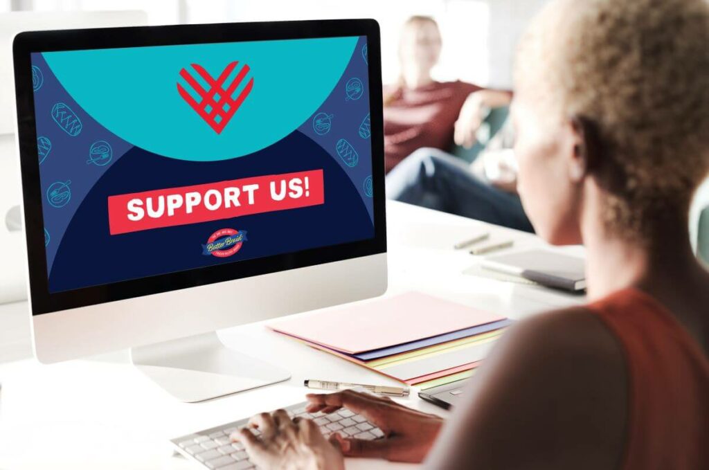 Woman at a computer with "Support Us" on the screen. The Butter Braid Pastry logo and GivingTuesday heart are also on the screen.