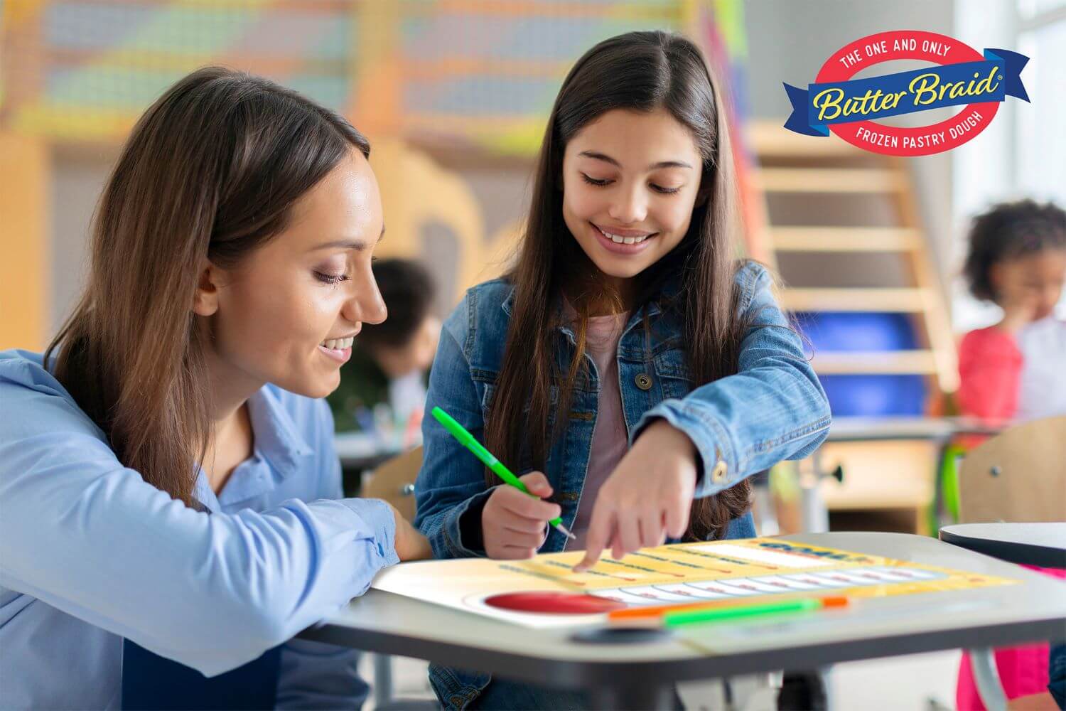 Tips to Help Sellers Meet Individual Goals - Teacher at an elementary school student's desk. Both are looking at a goal thermometer at her desk and filling it in.