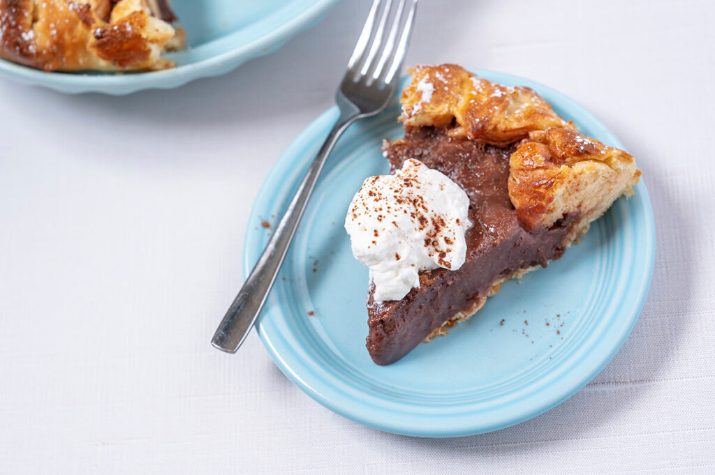 A slice of Black Forest Galette Pastry on a small plate with a fork.