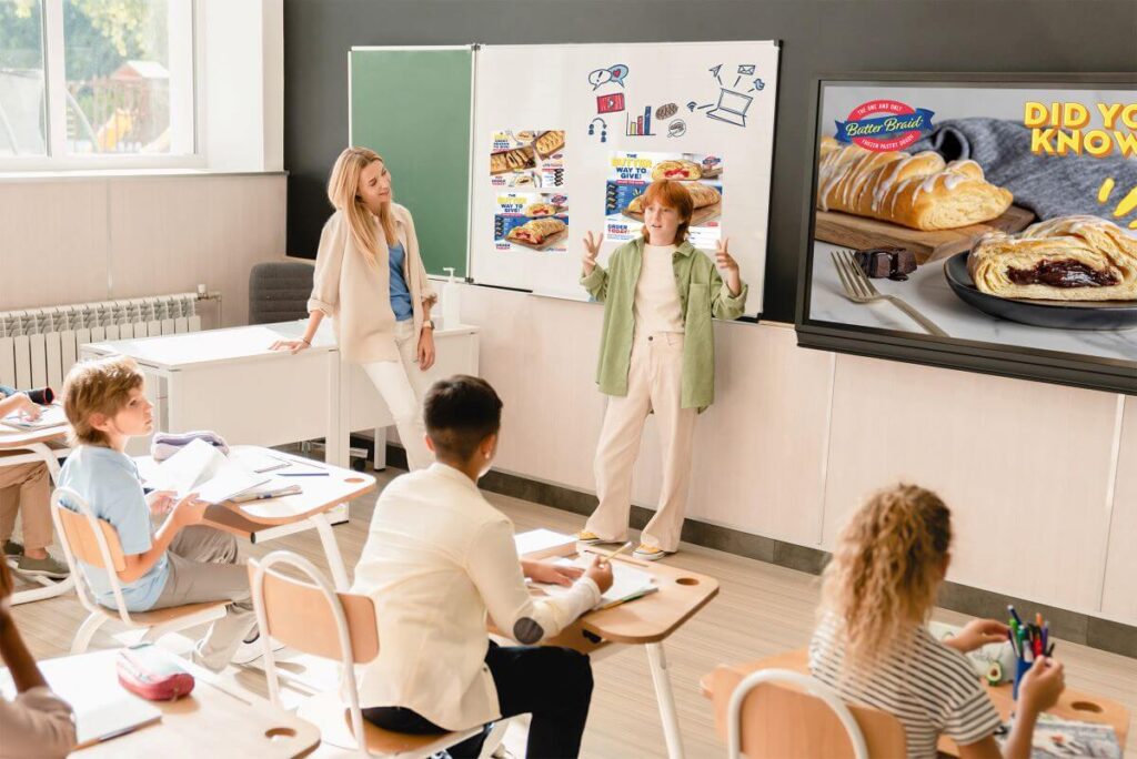 A classroom of middle school students watching a the fundraising kick off presentation for their upcoming Butter Braid® Pastry fundraiser.