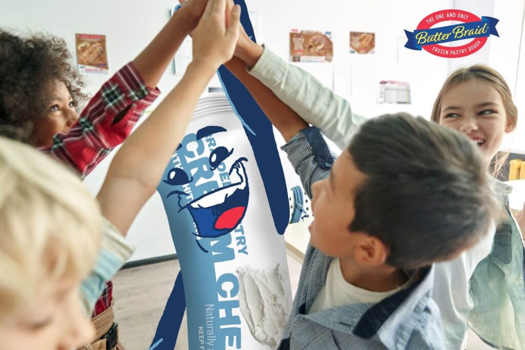 A group of middle schoolers high-fiving. The figure in the middle is a Cream Cheese Pastry Pal.