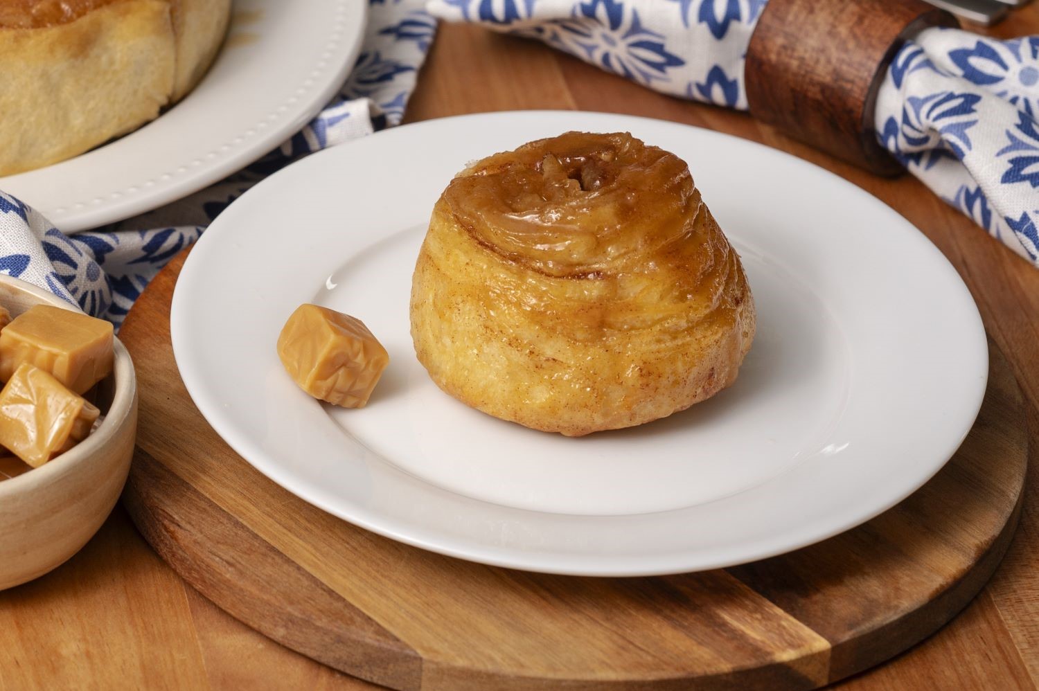 A single Caramel Butter Braid Pastry Roll on a plate.