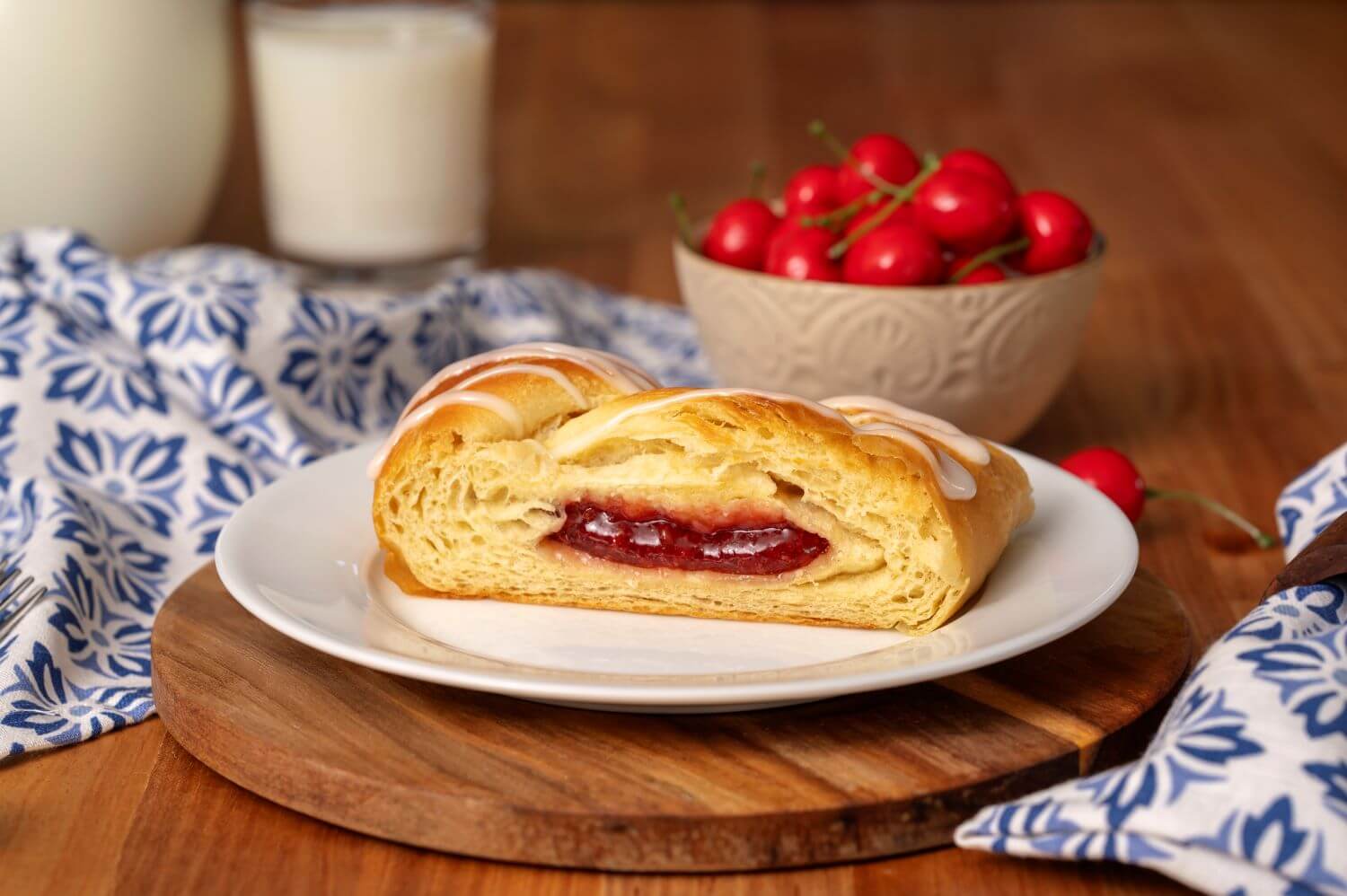 Slice of Cherry Butter Braid Pastry on a plate.