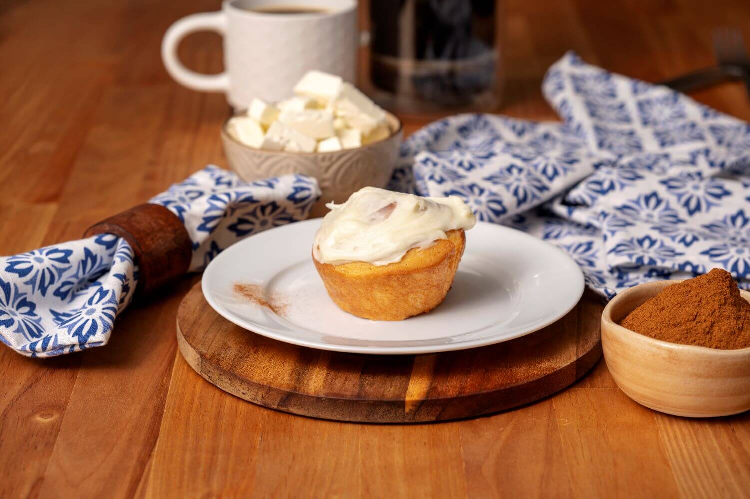 A single, iced Cinnamon Butter Braid Pastry Roll on a plate.