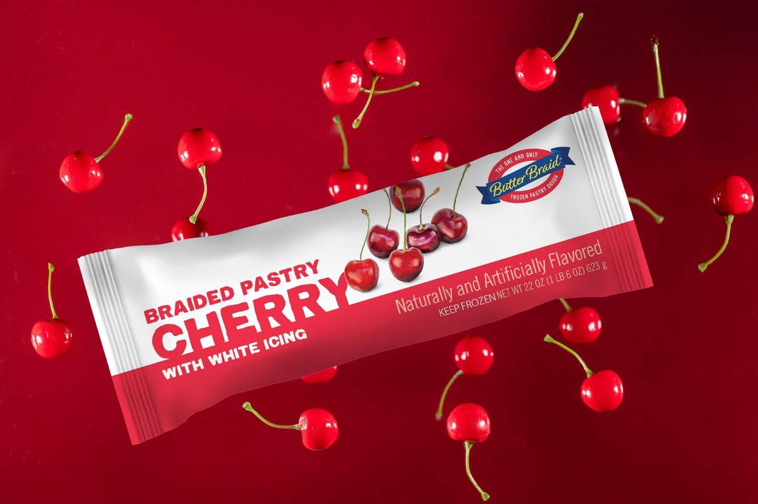 Cherry Butter Braid Pastry Packaging on a dark red background with fresh cherries.