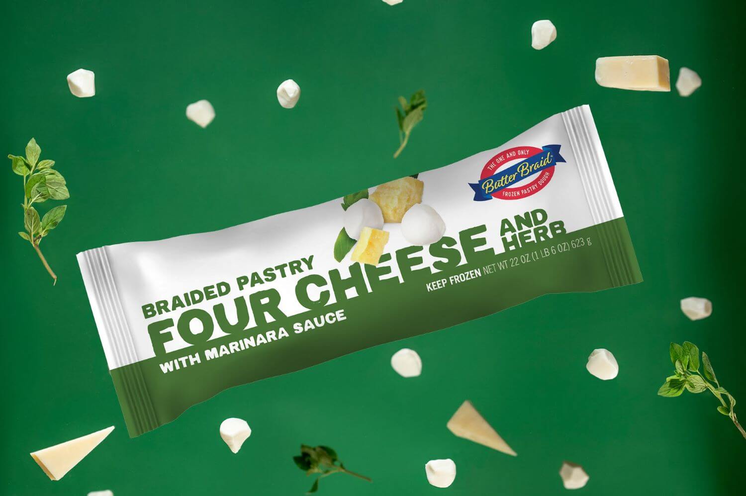 Four Cheese and Herb Butter Braid Pastry Packaging on a dark green background with chunks of various cheeses and sprigs of herbs.
